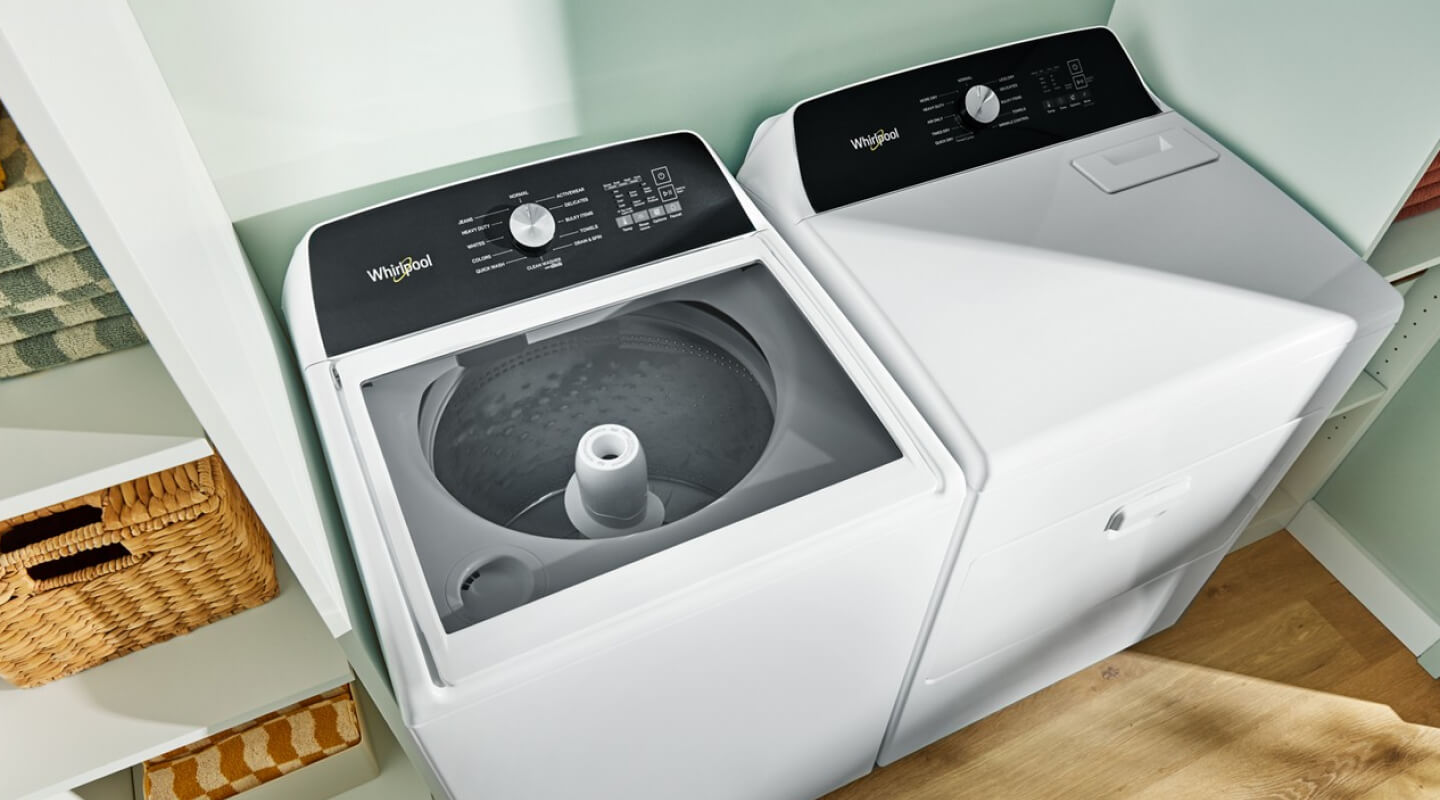A white, matching top-load Whirlpool® Washer and Dryer