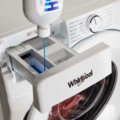 Detergent being loaded into a Whirlpool® Washer