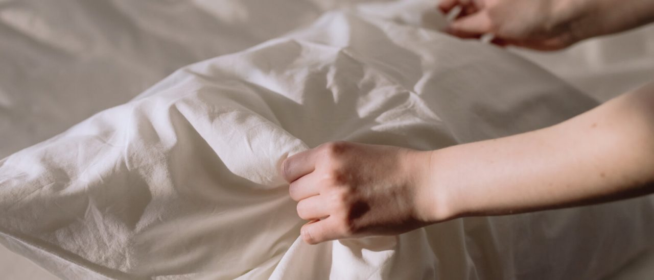 Hands holding a clean, white pillow Hands holding a clean, white pillow