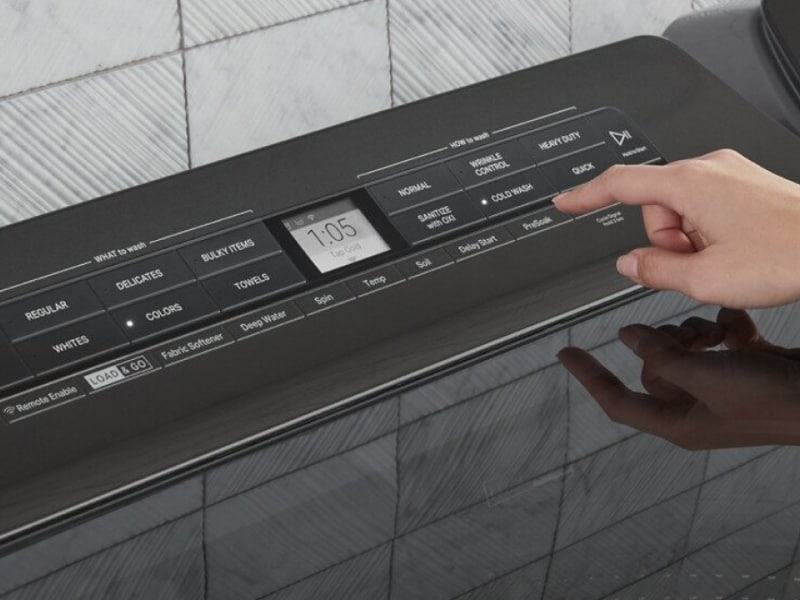 A woman programming the settings of a Whirlpool® dryer panel A woman programming the settings of a Whirlpool® dryer panel