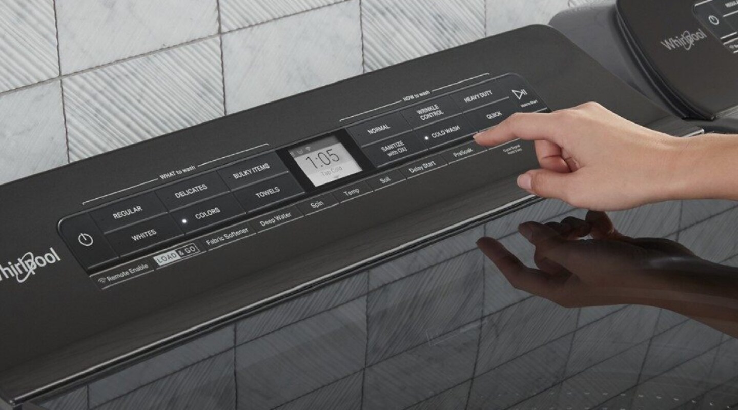 A woman programming the settings of a Whirlpool® dryer panel A woman programming the settings of a Whirlpool® dryer panel