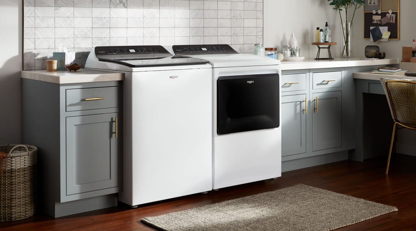 A matching white Whirlpool® Washer and Dryer pair in a laundry room