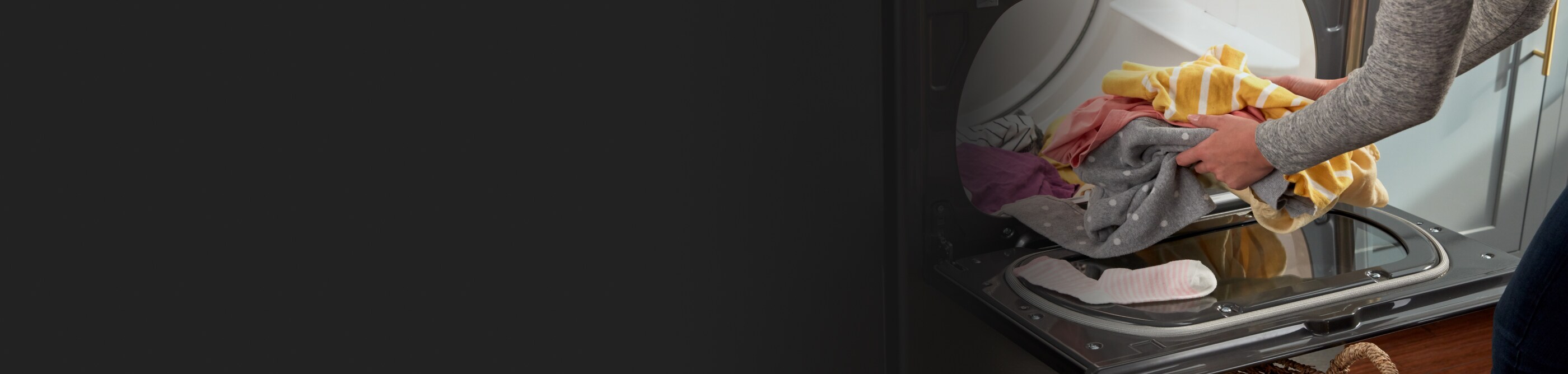 Person unloading a Whirlpool® dryer