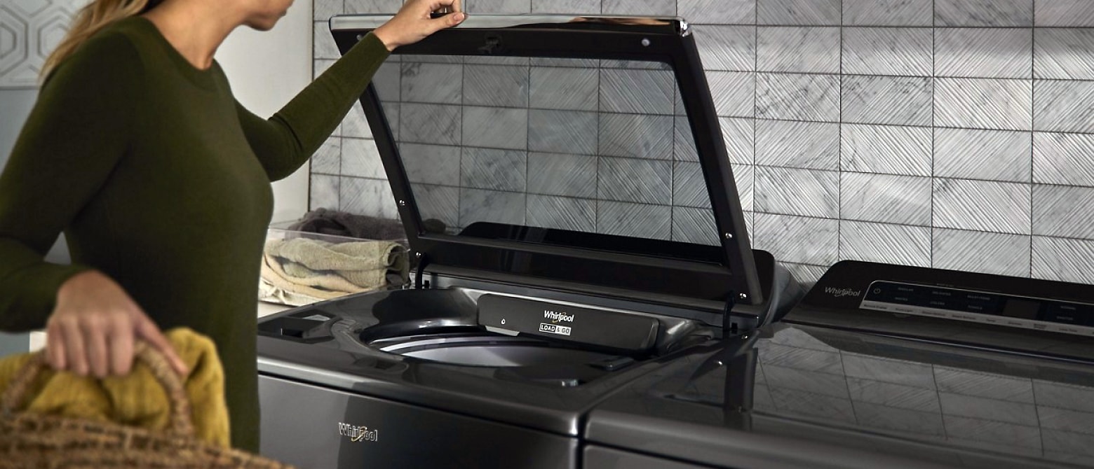 Woman opening a Whirlpool® Washer Woman opening a Whirlpool® Washer