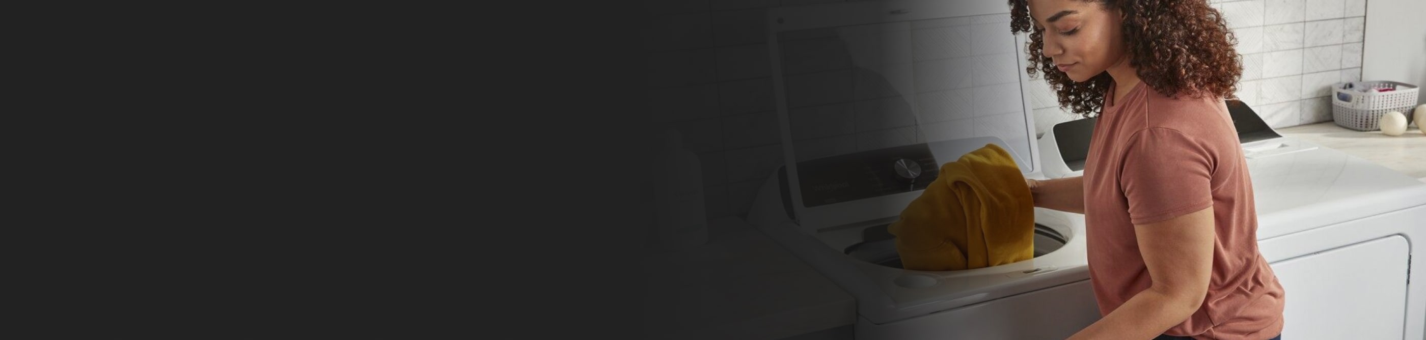 Person placing clothing in a washing machine