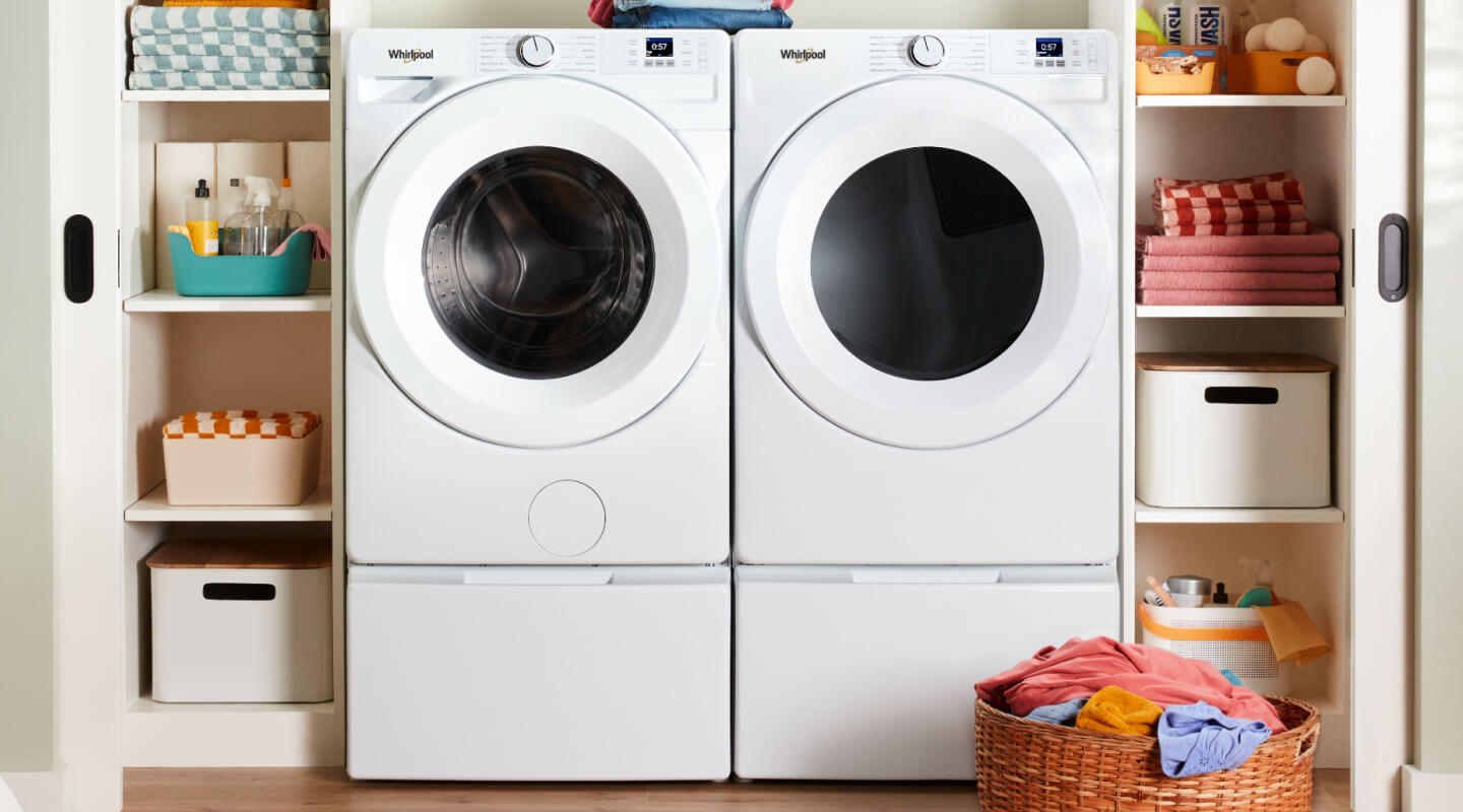 A neat laundry room with a washer and dryer side by side