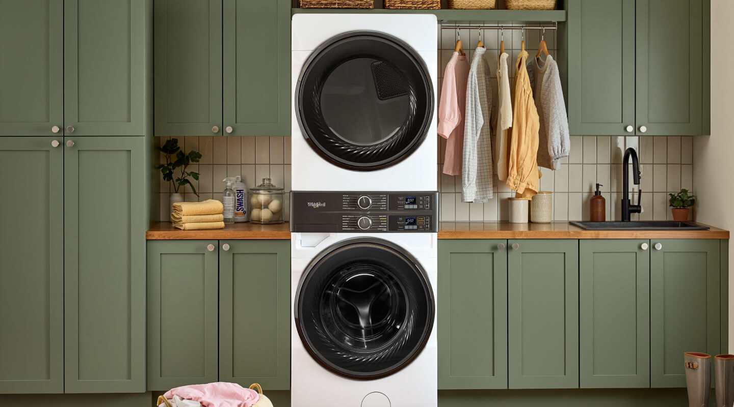 A laundry room with a stacked washer and dryer