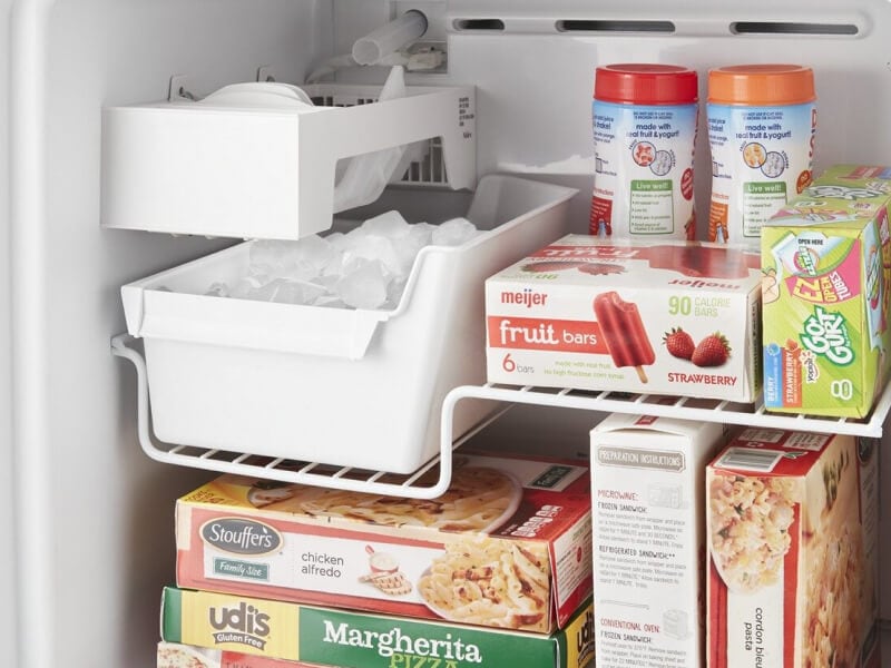 Close-up of full ice maker bin inside of freezer compartment