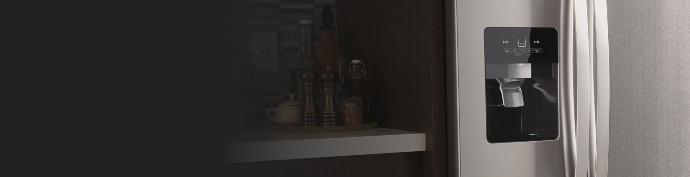 Close up of silver refrigerator ice maker chute