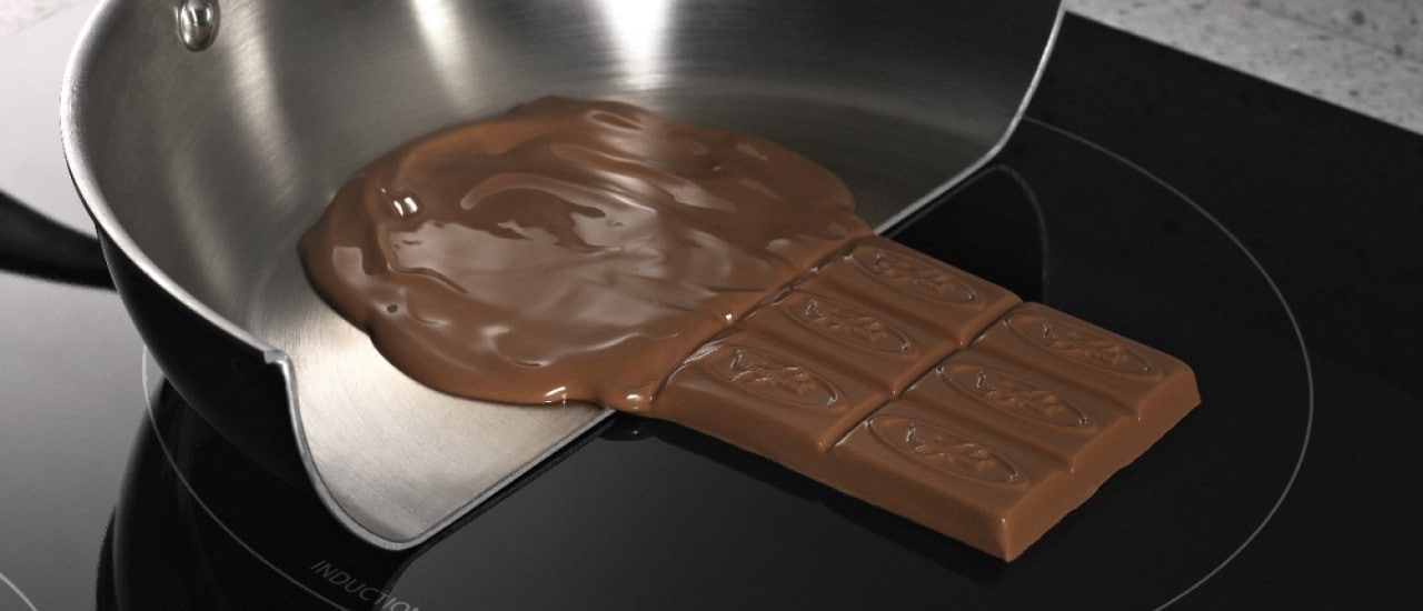 Chocolate melting in a pan and solid on an induction cooktop surface  Chocolate melting in a pan and solid on an induction cooktop surface