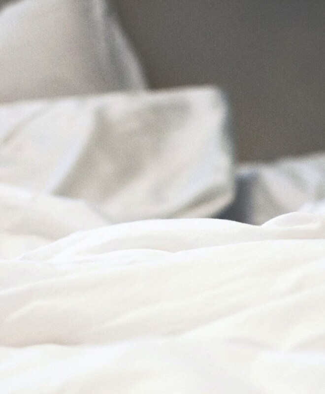 A closeup of a white comforter