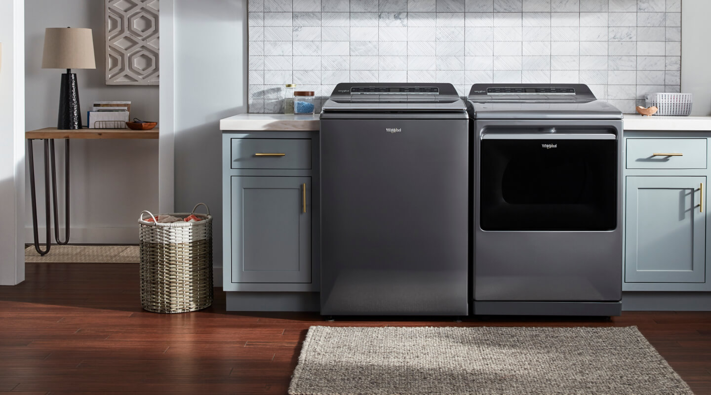 Top load washer and dryer in a laundry room