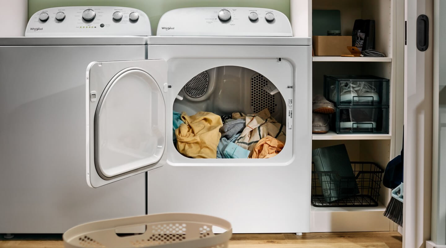 A white Whirlpool® Washer and Dryer pair in a laundry area