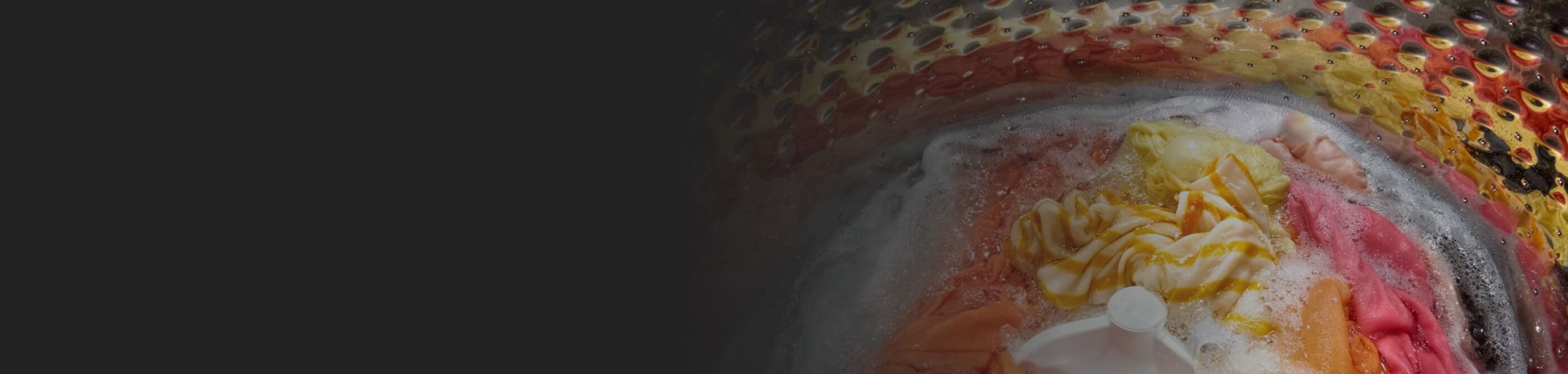 Clothing in washer drum sitting in soapy water