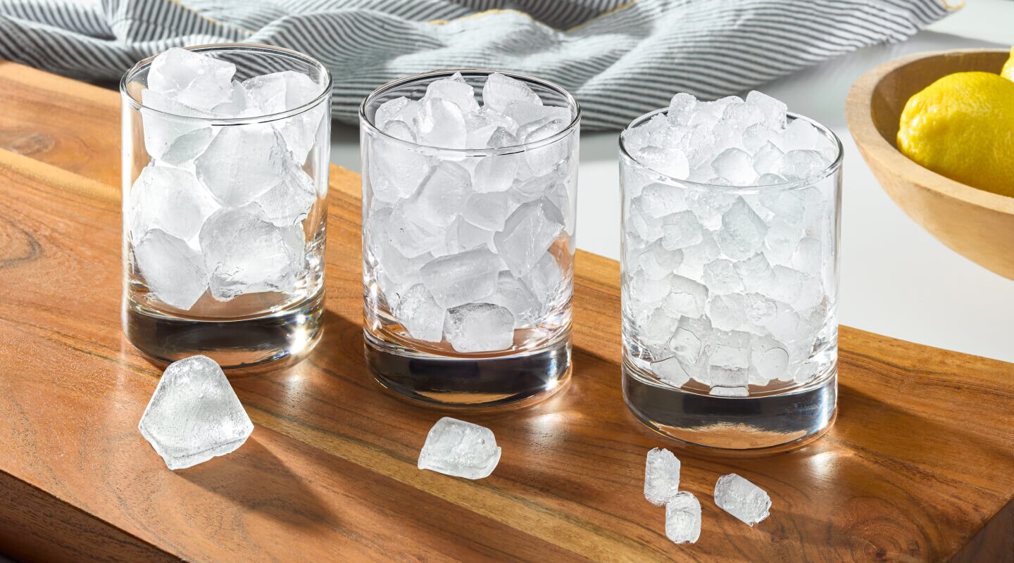 Three glasses filled with different types of ice