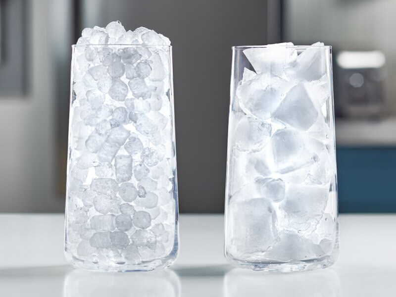 A glass full of nugget ice next to a glass full of traditional ice