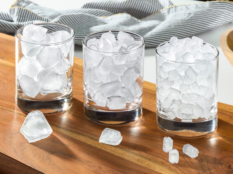 Three glasses filled with different types of ice