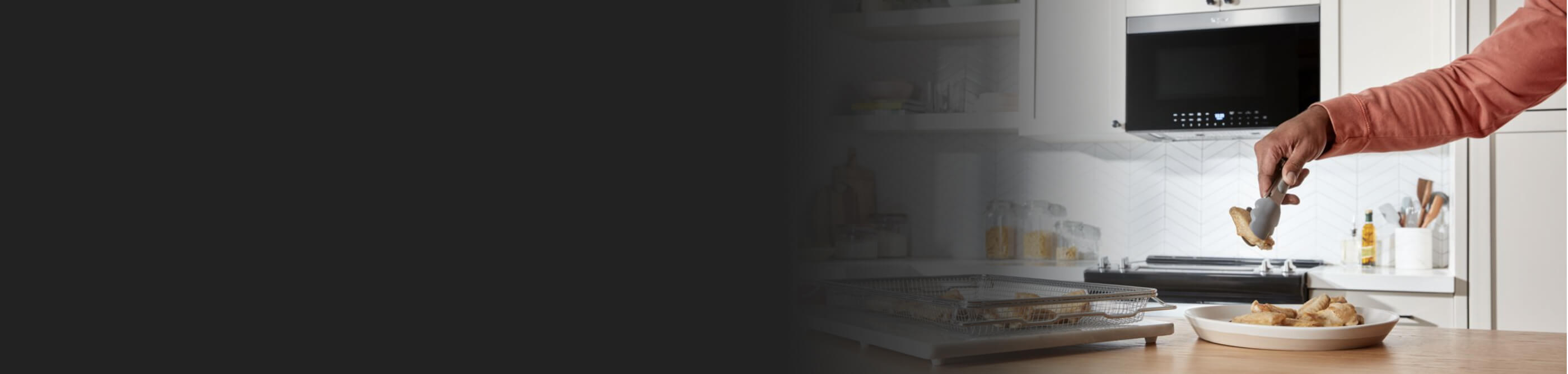 Person removing food from air fry basket with tongs