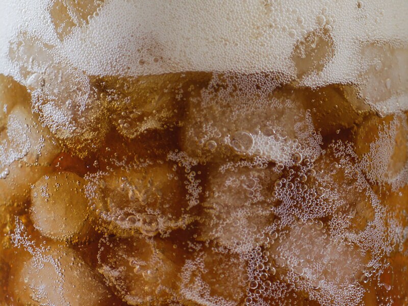 Close-up of nugget ice in a glass of soda