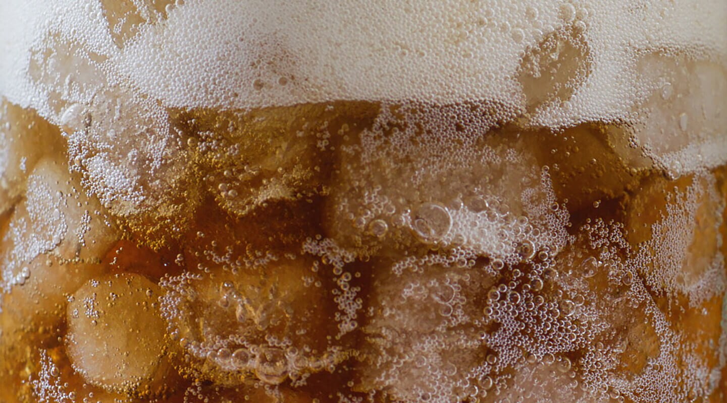 Close-up of nugget ice in a glass of soda
