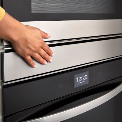 Person closing an oven