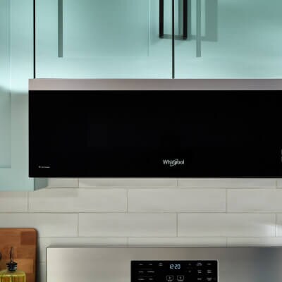 Whirlpool® Low Profile Over-the-Range Microwave in blue cabinetry
