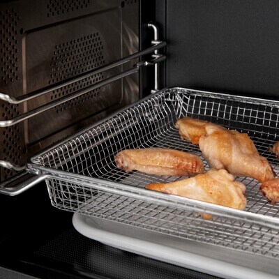 Air fry basket cooking chicken wings in microwave