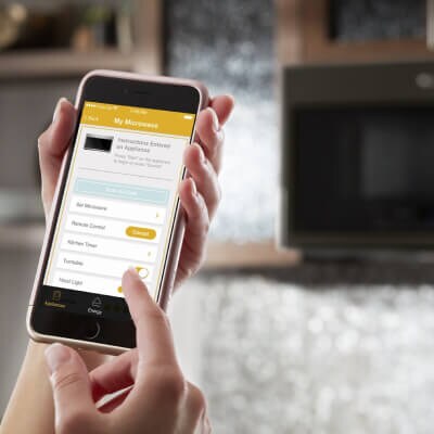 Person selecting settings on Whirlpool® App