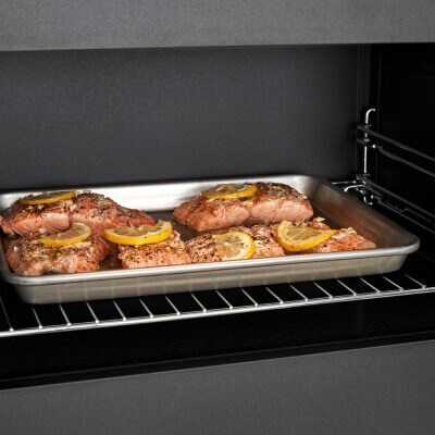 Salmon cooking on a tray inside a convection microwave