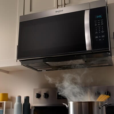 Stockpot of spaghetti cooking below a Whirlpool® Over-the-Range Microwave