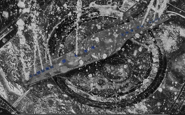 Stainless steel dishwasher tub and spray arm spraying water