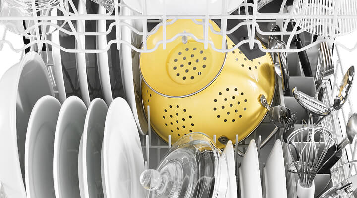 Dishes arranged inside a dishwasher Dishes arranged inside a dishwasher