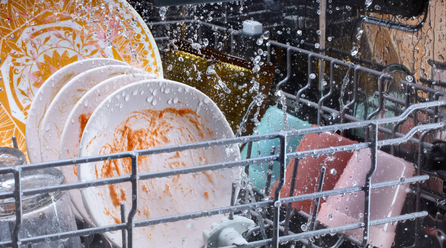 Dirty dishes washing in a dishwasher Dirty dishes washing in a dishwasher