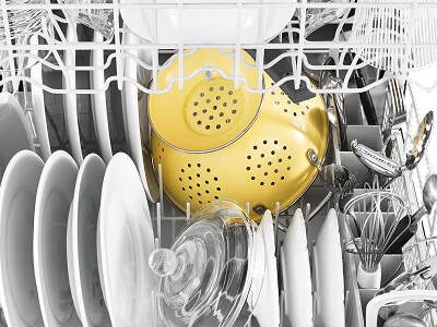 Dishes arranged inside a dishwasher Dishes arranged inside a dishwasher