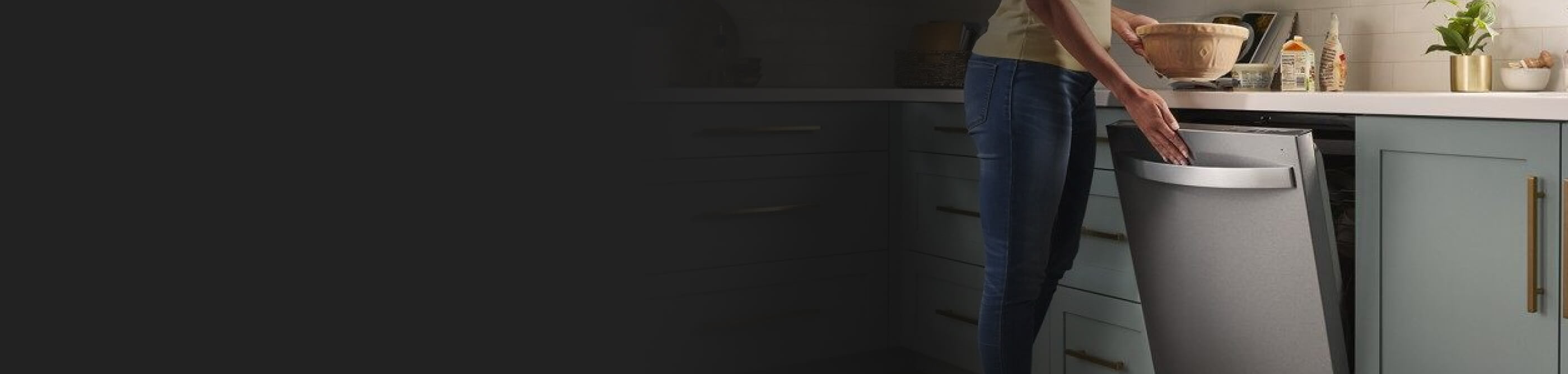 Person closing a stainless steel Whirlpool® Dishwasher