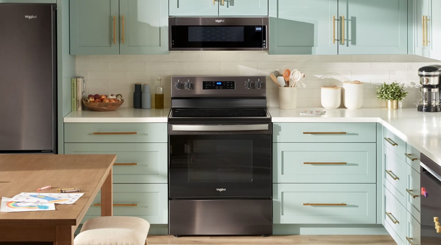 Whirlpool® Electric Range and Over-the-Counter Microwave in blue cabinetry