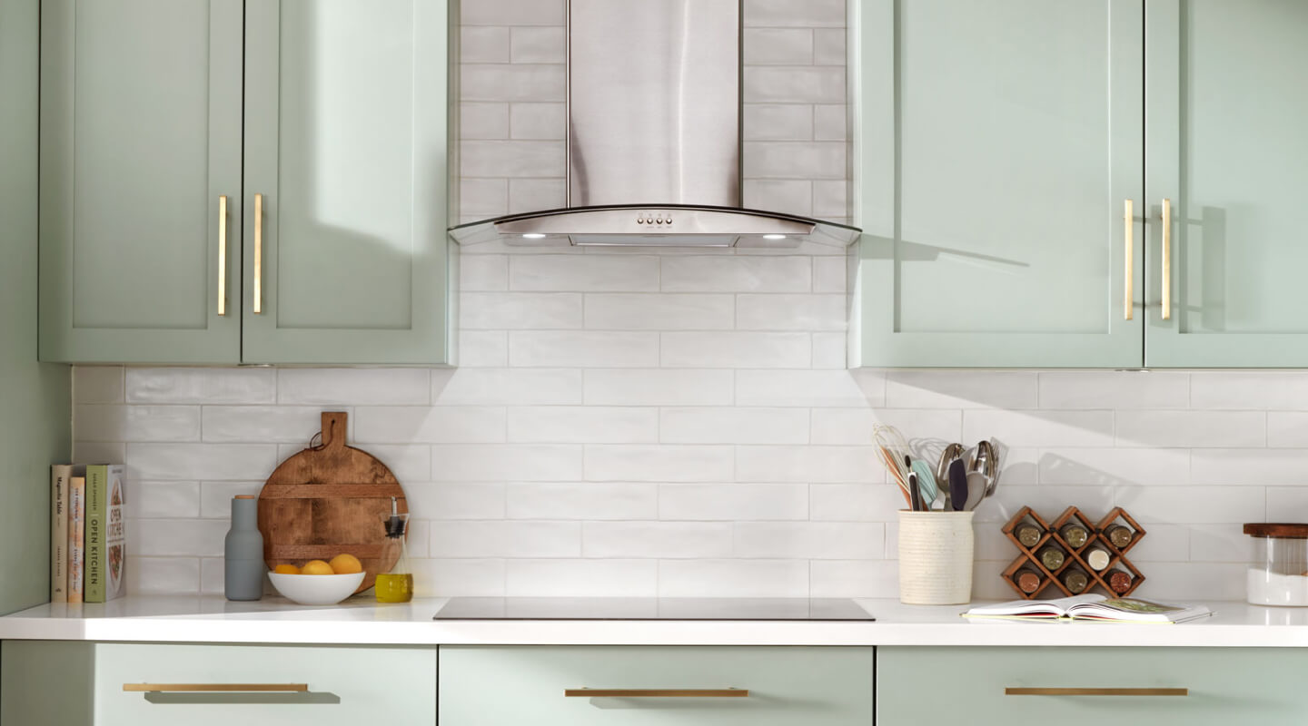 Range hood installed over an electric cooktop in a rustic kitchen Range hood installed over an electric cooktop in a rustic kitchen