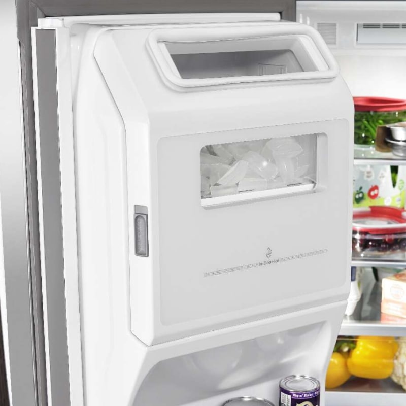 A refrigerator’s in-door ice maker full of ice