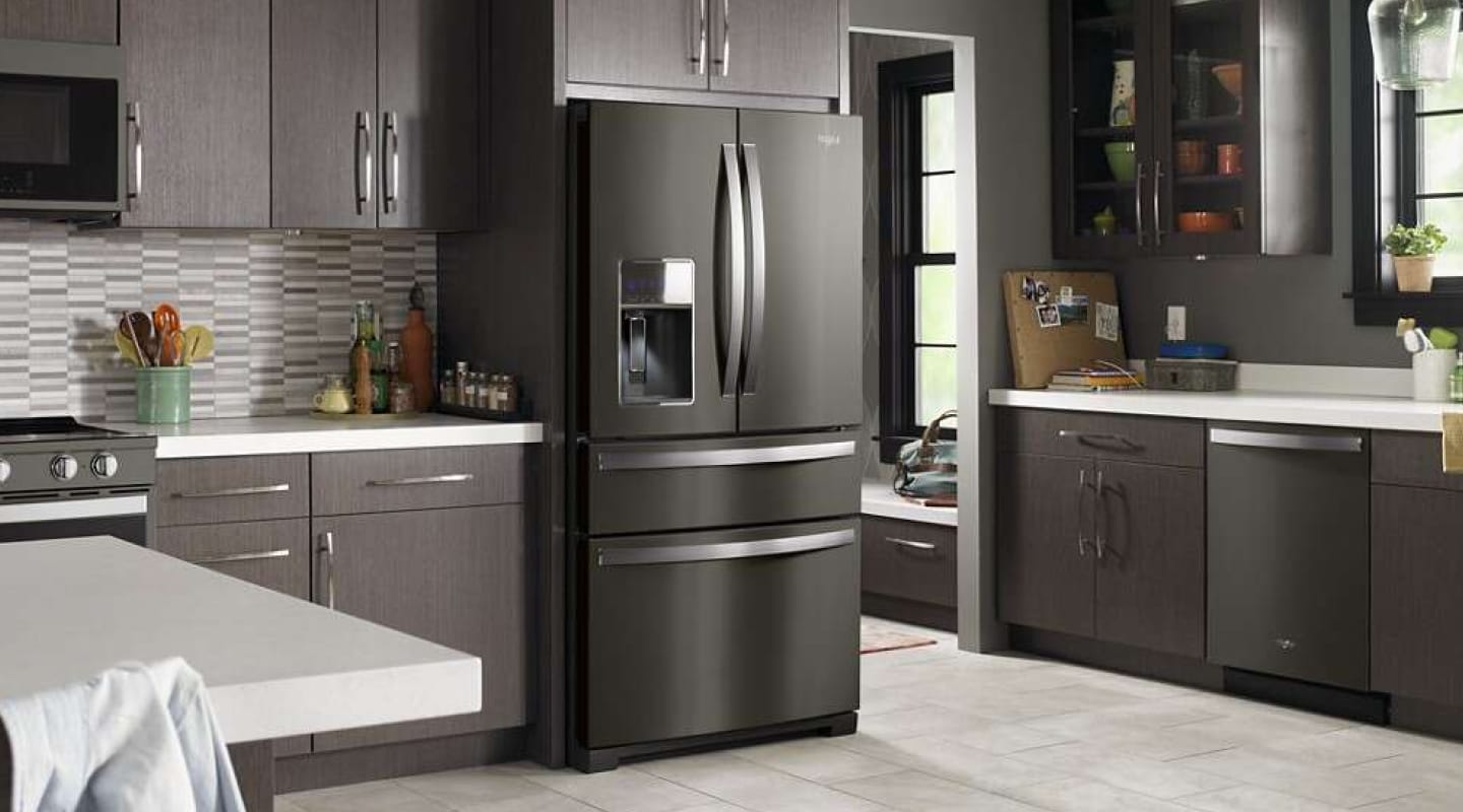 Black stainless Whirlpool® French Door Refrigerator in a modern kitchen with brown cabinets
