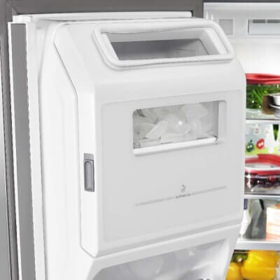 A refrigerator’s in-door ice maker full of ice