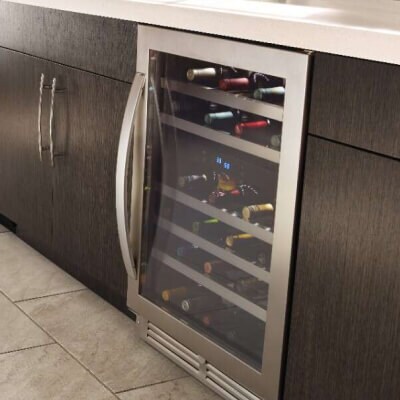 A Whirlpool® Undercounter Wine Refrigerator stocked with wine bottles