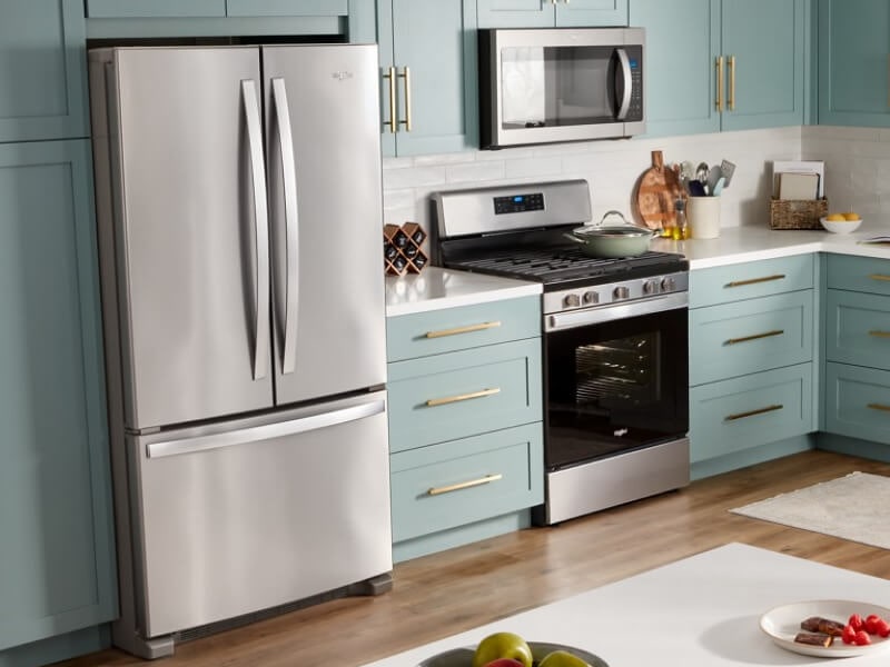 Whirlpool® Stainless Steel French door Refrigerator in baby blue cabinetry with gold cabinet pulls