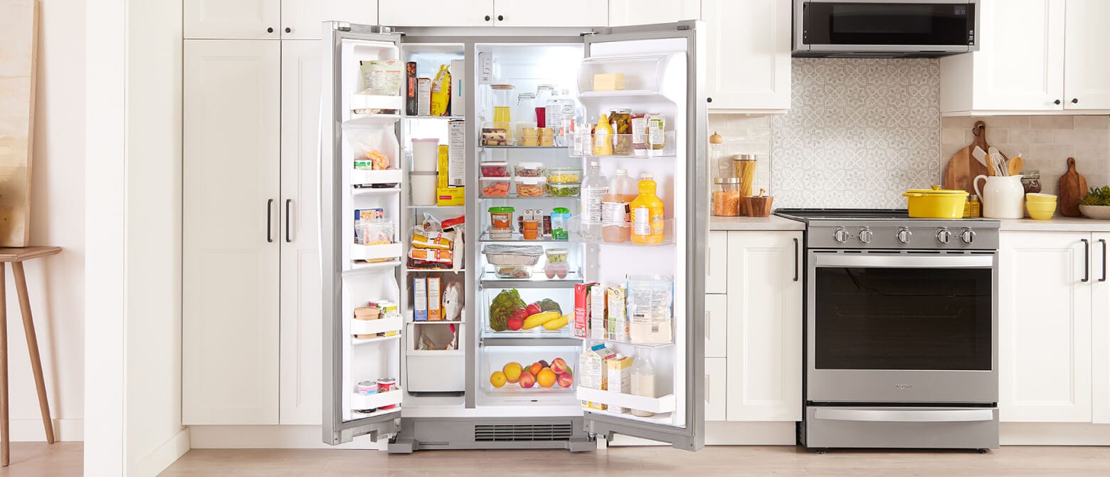 A side-by-side refrigerator with both doors opened to reveal a fully stocked interior