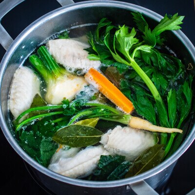 Root vegetables soaking in water in a colander