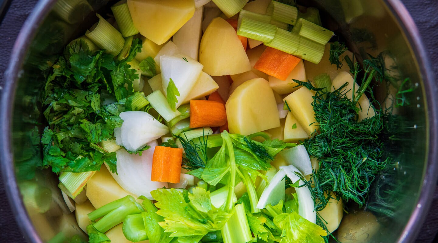 Chopped root vegetables in a colander