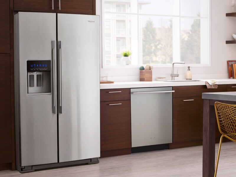 A modern wood cabinet kitchen with a counter depth refrigerator A modern wood cabinet kitchen with a counter depth refrigerator