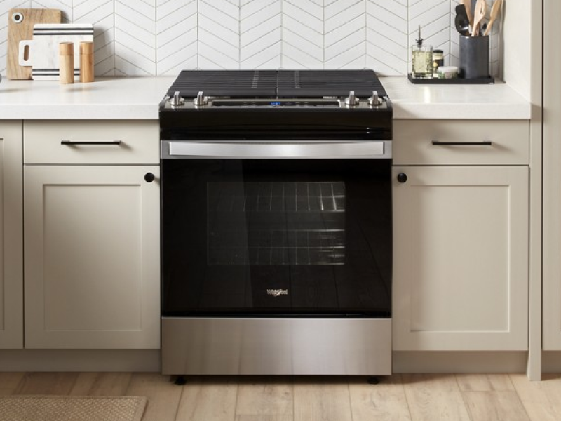 A black slide-in range in a rustic kitchen A black slide-in range in a rustic kitchen