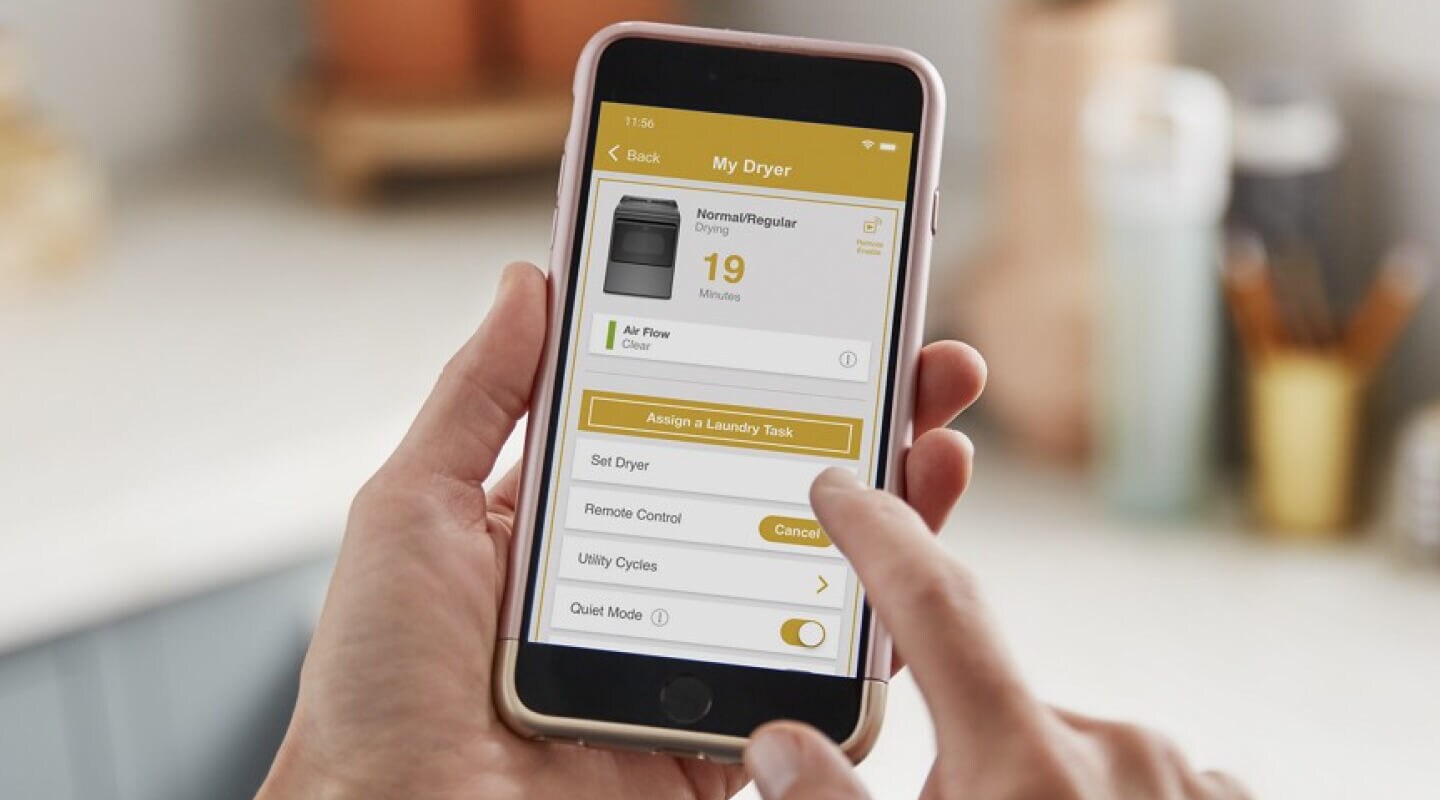 Person adjusting dryer settings on the Whirlpool® App Person adjusting dryer settings on the Whirlpool® App
