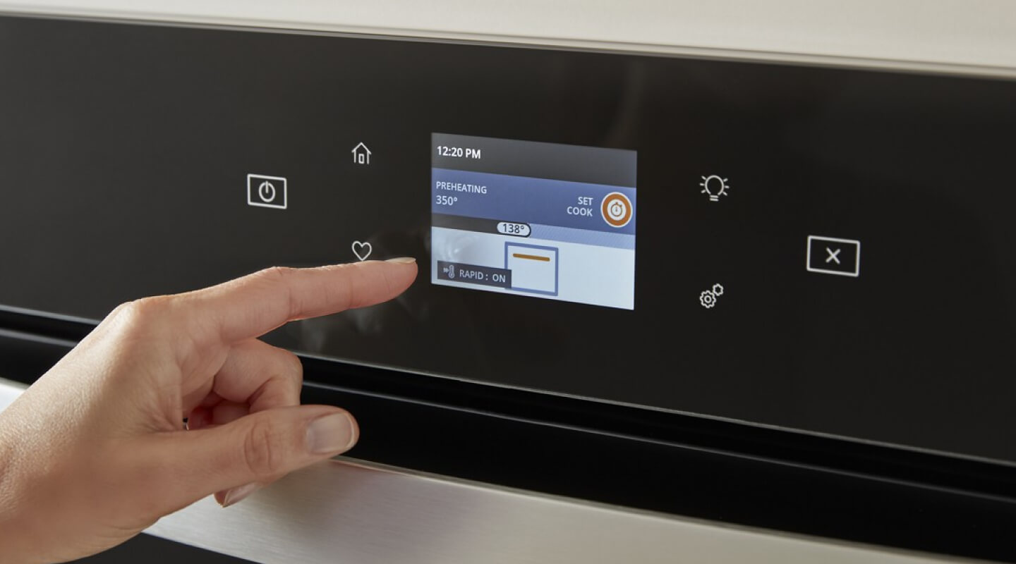 Person selecting settings on an appliance touchscreen Person selecting settings on an appliance touchscreen