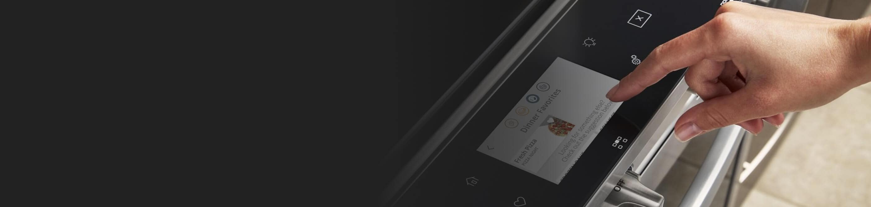 Person selecting settings on an oven touch screen control panel